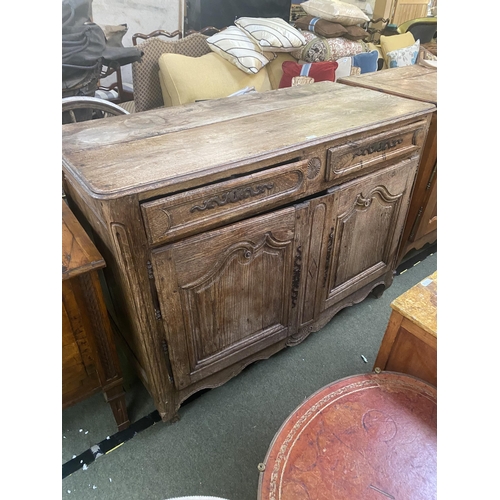 661 - A C19th French oak rustic sideboard, with 2 short drawers over two cupboard doors, with much wear an... 