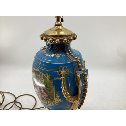 216 - A pair of Continental Meissen Style lamps, on stepped gilded base, the blue body with central oval p... 