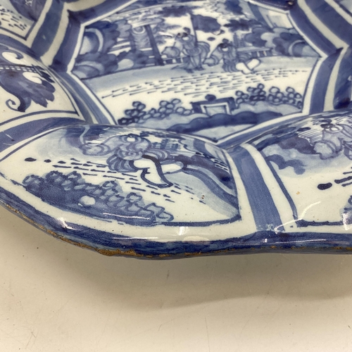 228 - An oriental style blue and white slip ware , 9 lobbed Frankfurt Faience 