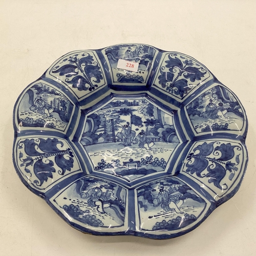 228 - An oriental style blue and white slip ware , 9 lobbed Frankfurt Faience 