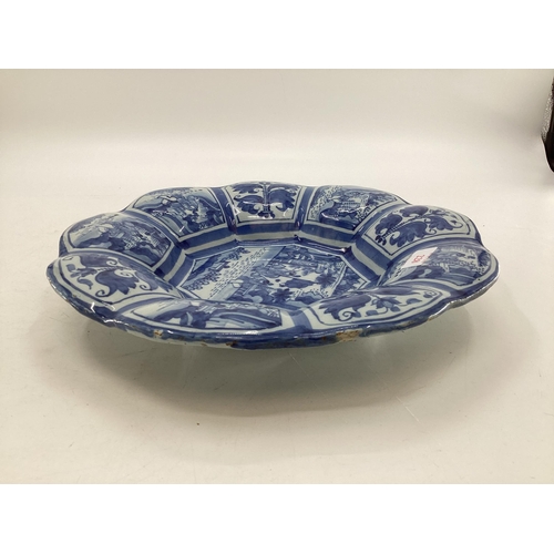 228 - An oriental style blue and white slip ware , 9 lobbed Frankfurt Faience 