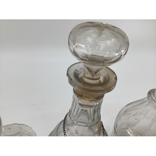 230 - A collection of C19th/C20th glass decanters, a triple ring necked example, some with white metal lab... 