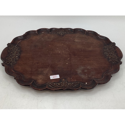 423 - AN oriental style carved wooden tray together with a framed and glazed print style