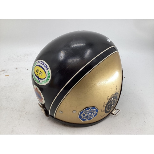 439 - A collection of motorcycle related items, an ATS leather helmet, a vintage helmet with BSA gold star... 