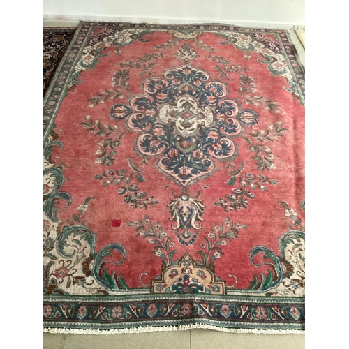 673 - A rug with red central ground, and with all over floral and multi stylized borders