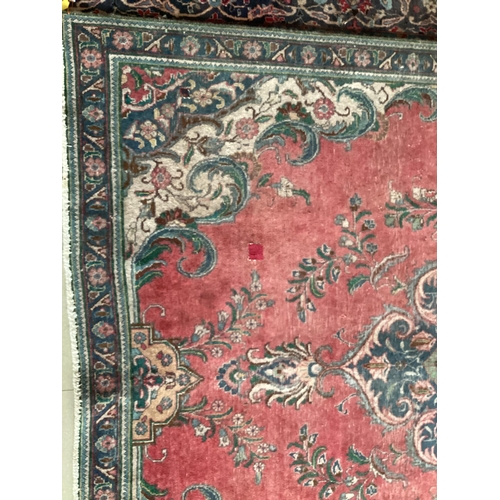 673 - A rug with red central ground, and with all over floral and multi stylized borders