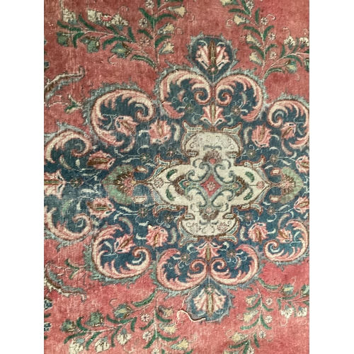 673 - A rug with red central ground, and with all over floral and multi stylized borders