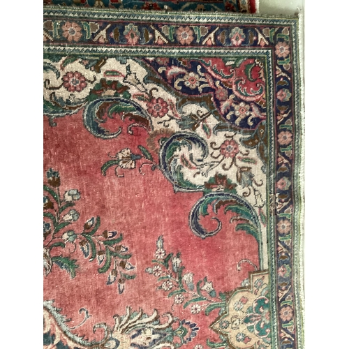 673 - A rug with red central ground, and with all over floral and multi stylized borders