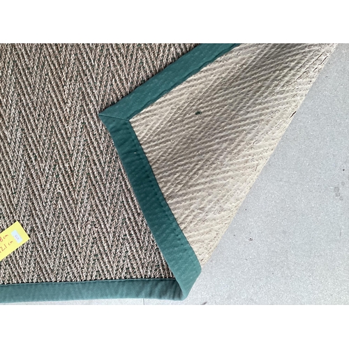 675 - A Sisal Runner rug, 488 x 121cm, with green material edging