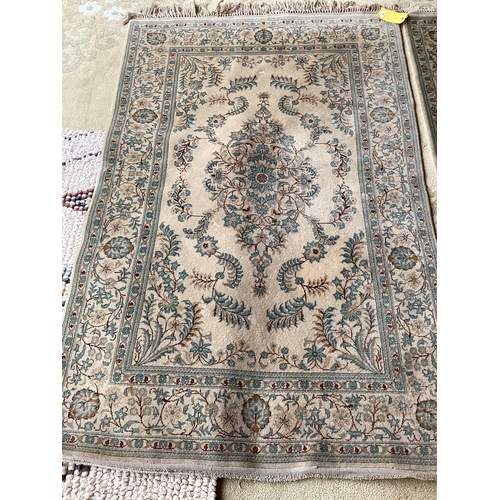 688 - An excellent quality  near pair of rugs, Persian, silk and wool, with beige ground and blue floral d... 