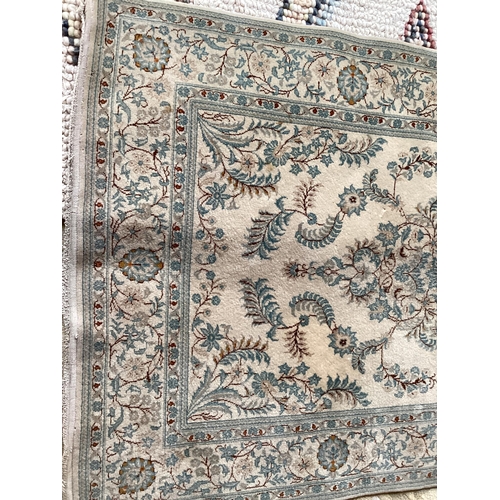 688 - An excellent quality  near pair of rugs, Persian, silk and wool, with beige ground and blue floral d... 