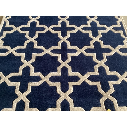 689 - An excellent quality, as new from original packaging,  dark blue and ivory coloured Indian rug, labe... 