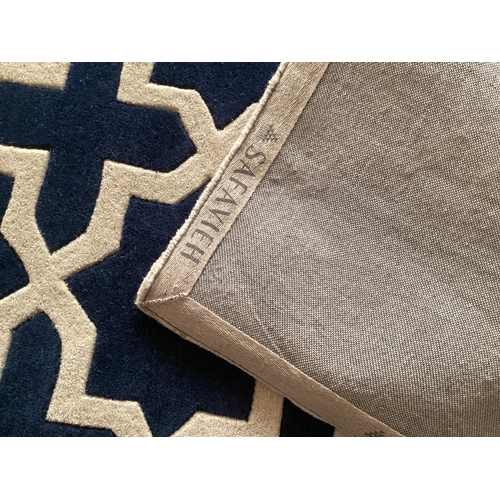 689 - An excellent quality, as new from original packaging,  dark blue and ivory coloured Indian rug, labe... 