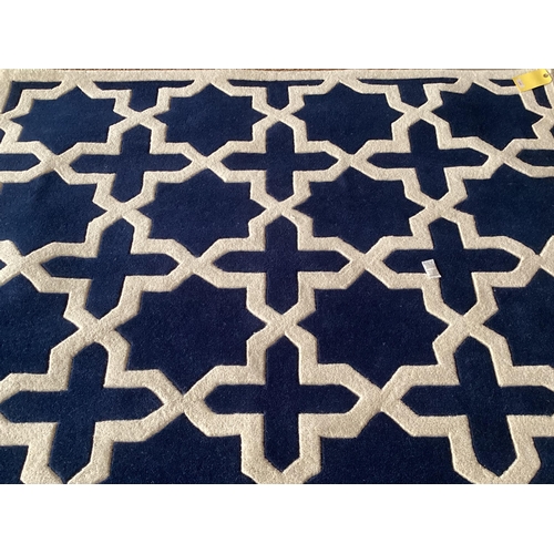 690 - An excellent quality, as new, from original packaging, dark blue and ivory coloured Indian rug, labe... 