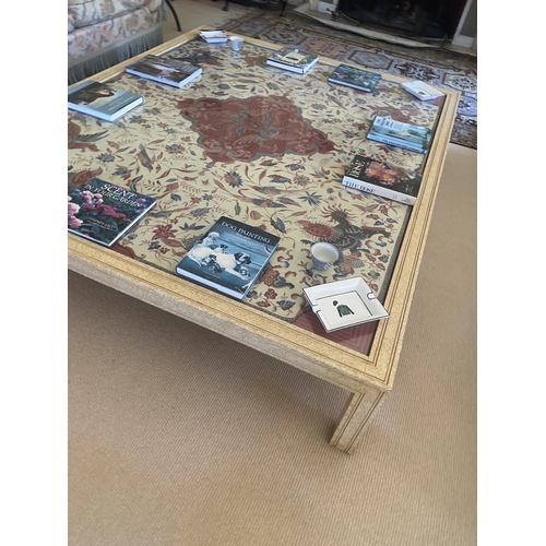 562 - A large modern cream painted low centre table, the central glass top covering a fabric, 40H x 218W x... 