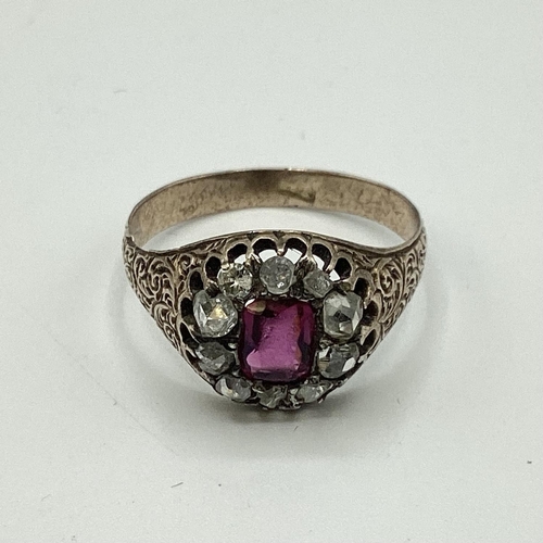 10 - An unmarked yellow metal 18th century ruby and diamond dress ring. Central cushion cut ruby of good ... 