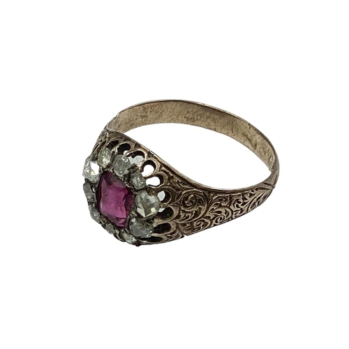 10 - An unmarked yellow metal 18th century ruby and diamond dress ring. Central cushion cut ruby of good ... 