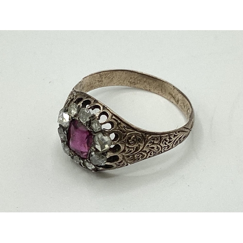 10 - An unmarked yellow metal 18th century ruby and diamond dress ring. Central cushion cut ruby of good ... 