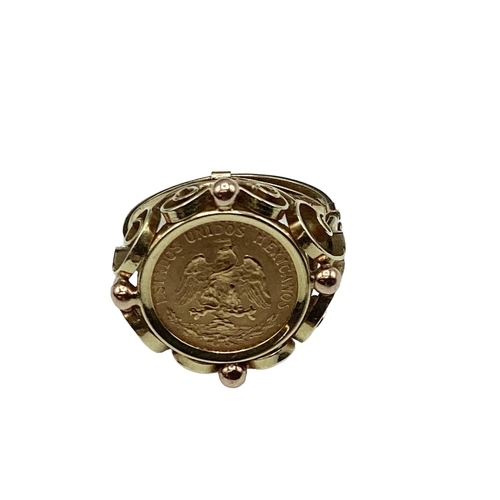 12 - A coin signet ring. Mexican two peso coin in an unmarked yellow metal mount. 4.40g. Size K.