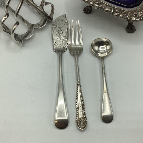 14 - A sterling silver Elkington and Co toast rack together with a sterling silver fork, a plated salt an... 