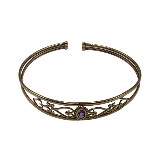 15 - A 9ct gold pierced bangle bracelet set with single amethyst together with a 9ct gold crucifix pendan... 