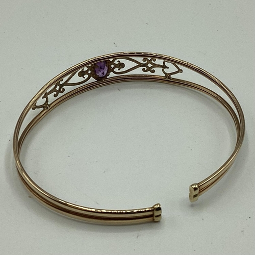 15 - A 9ct gold pierced bangle bracelet set with single amethyst together with a 9ct gold crucifix pendan... 