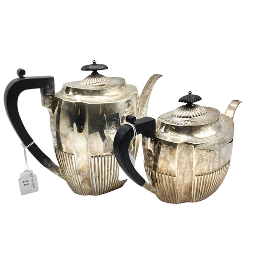 22 - A sterling silver two piece tea set with half reeded design and ebonised handle. Approx 32ozt Sheffi... 