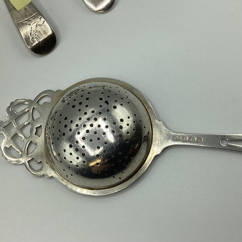 23 - A collection of sterling silver flatware together with a silver tea strainer. 363g.