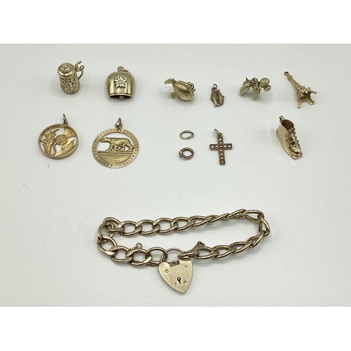 28 - A 9 ct gold flat link charm bracelet with A 9ct gold heart locket together with 10 9 ct gold and unm... 