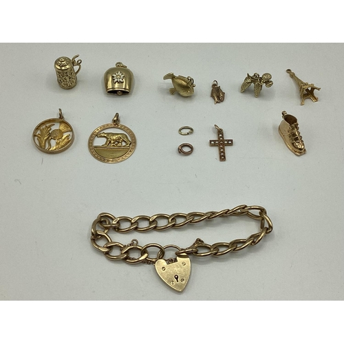 28 - A 9 ct gold flat link charm bracelet with A 9ct gold heart locket together with 10 9 ct gold and unm... 