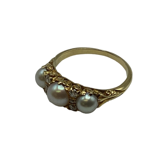 39 - An 18 ct gold pearl and diamond set ring, 3 half pearls with old cut diamond separators to a scrolli... 