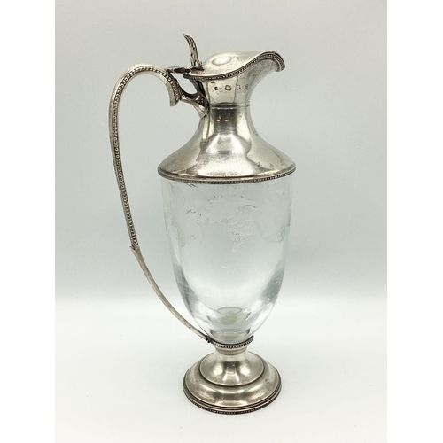 4 - A sterling silver claret jug with etched leaf and vine decoration. JM London, 1998. 26cm(h)