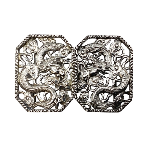 49 - A Chinese silver two part buckle with stylised dragon decoration by Hung Chong and CO Hong Kong circ... 