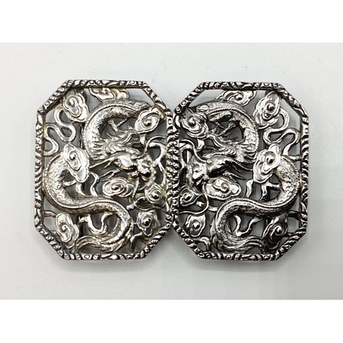 49 - A Chinese silver two part buckle with stylised dragon decoration by Hung Chong and CO Hong Kong circ... 