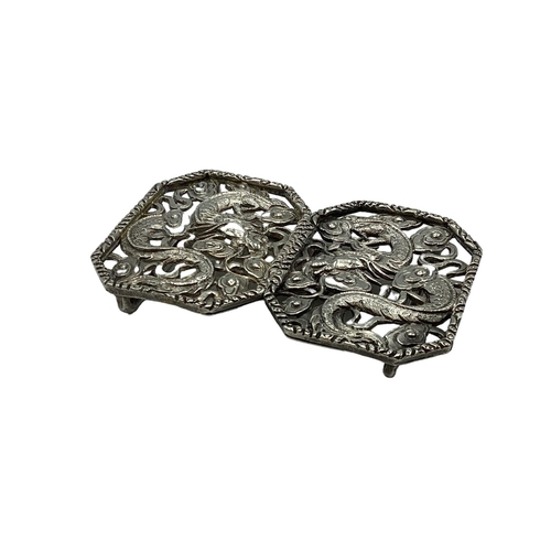 49 - A Chinese silver two part buckle with stylised dragon decoration by Hung Chong and CO Hong Kong circ... 