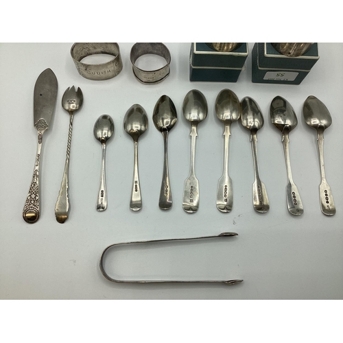 55 - A Collection (15 items) of sterling silver items to include napkin rings spoons, sugar tongs etc.  3... 