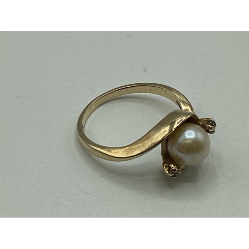 56 - A 9ct gold pearl and diamond set ring. Central pearl with diamond accents. 2.56g. Size M.