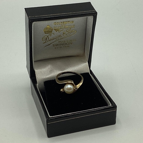 56 - A 9ct gold pearl and diamond set ring. Central pearl with diamond accents. 2.56g. Size M.