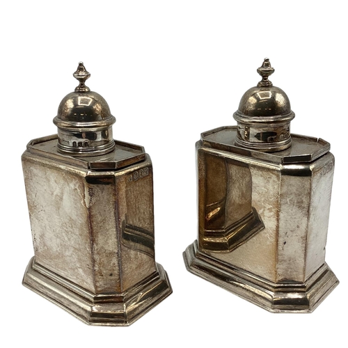 59 - A pair of Britannia sterling silver tea caddys. Hexagonal shape with stepped bases. With finialed to... 