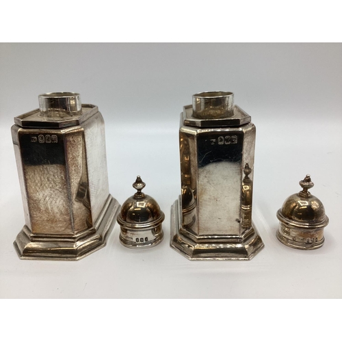 59 - A pair of Britannia sterling silver tea caddys. Hexagonal shape with stepped bases. With finialed to... 