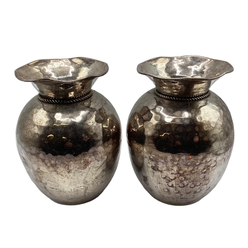 62 - A pair of white metal vases of bulbous form flared rims with planished finish.19cm H