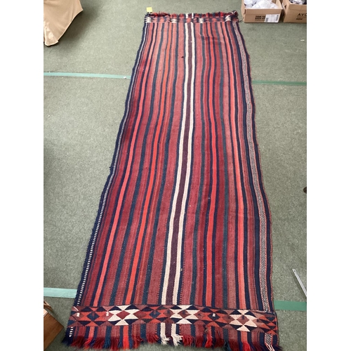 638 - A Kilim style runner, the red and blue stripes and kilim stylized pattern to end of the rug, 109/344... 