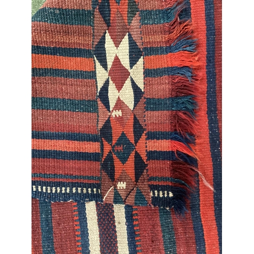 638 - A Kilim style runner, the red and blue stripes and kilim stylized pattern to end of the rug, 109/344... 