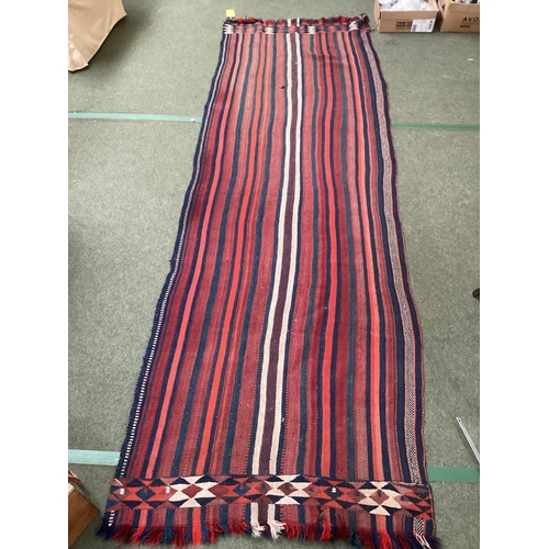 638 - A Kilim style runner, the red and blue stripes and kilim stylized pattern to end of the rug, 109/344... 