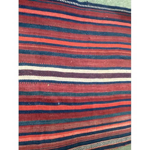 638 - A Kilim style runner, the red and blue stripes and kilim stylized pattern to end of the rug, 109/344... 