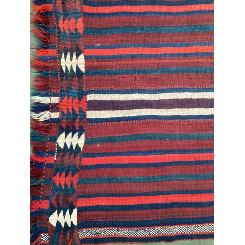 638 - A Kilim style runner, the red and blue stripes and kilim stylized pattern to end of the rug, 109/344... 