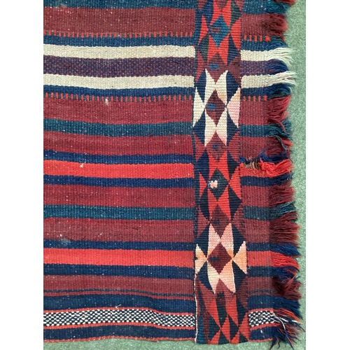 638 - A Kilim style runner, the red and blue stripes and kilim stylized pattern to end of the rug, 109/344... 