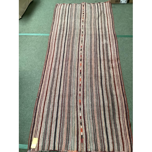 639 - A Kilim style rug/runner with all over stylized reds and greys stripes, 133/310cm