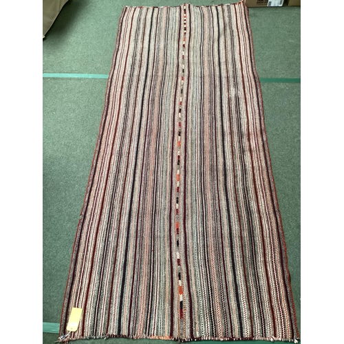 639 - A Kilim style rug/runner with all over stylized reds and greys stripes, 133/310cm