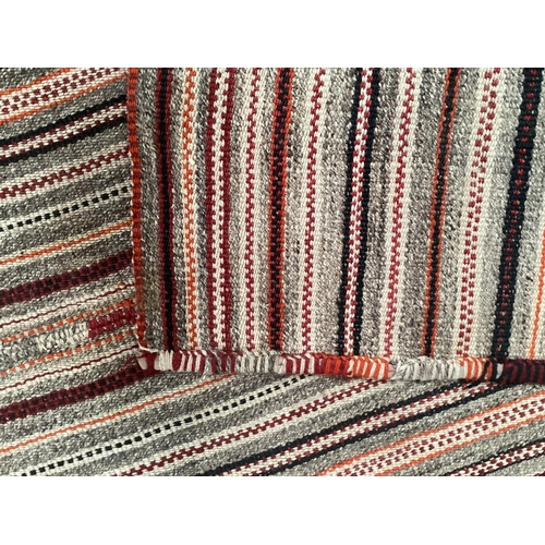 639 - A Kilim style rug/runner with all over stylized reds and greys stripes, 133/310cm